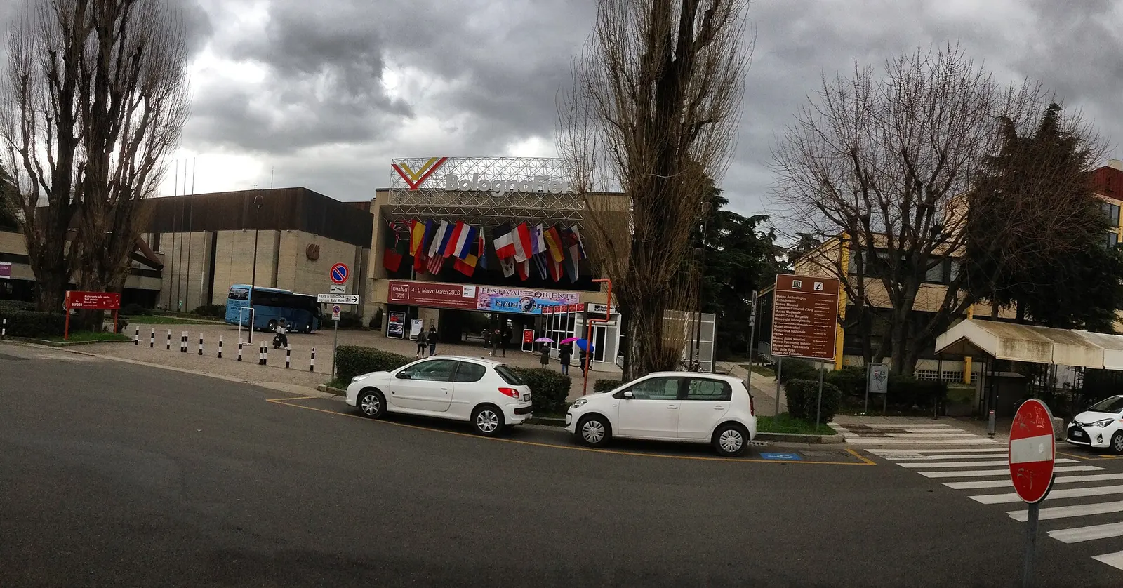 The BolognaFiere entrance with its rooftop sign and row of flags