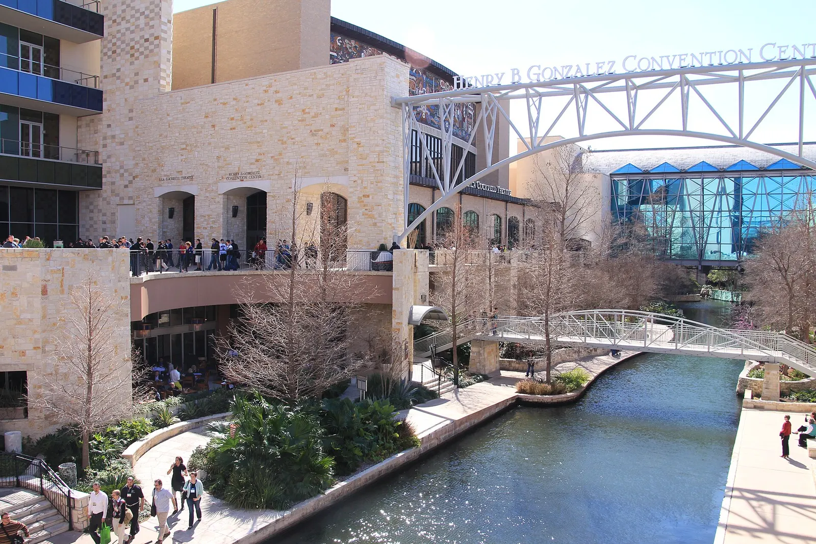 The Henry B. Gonzalez Convention Center on the San Antonio River Walk, with the convention center's name on the footbridge arch