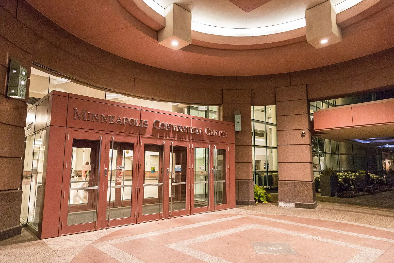 The red-granite entrance of the Minneapolis Convention Center with its name over the doors