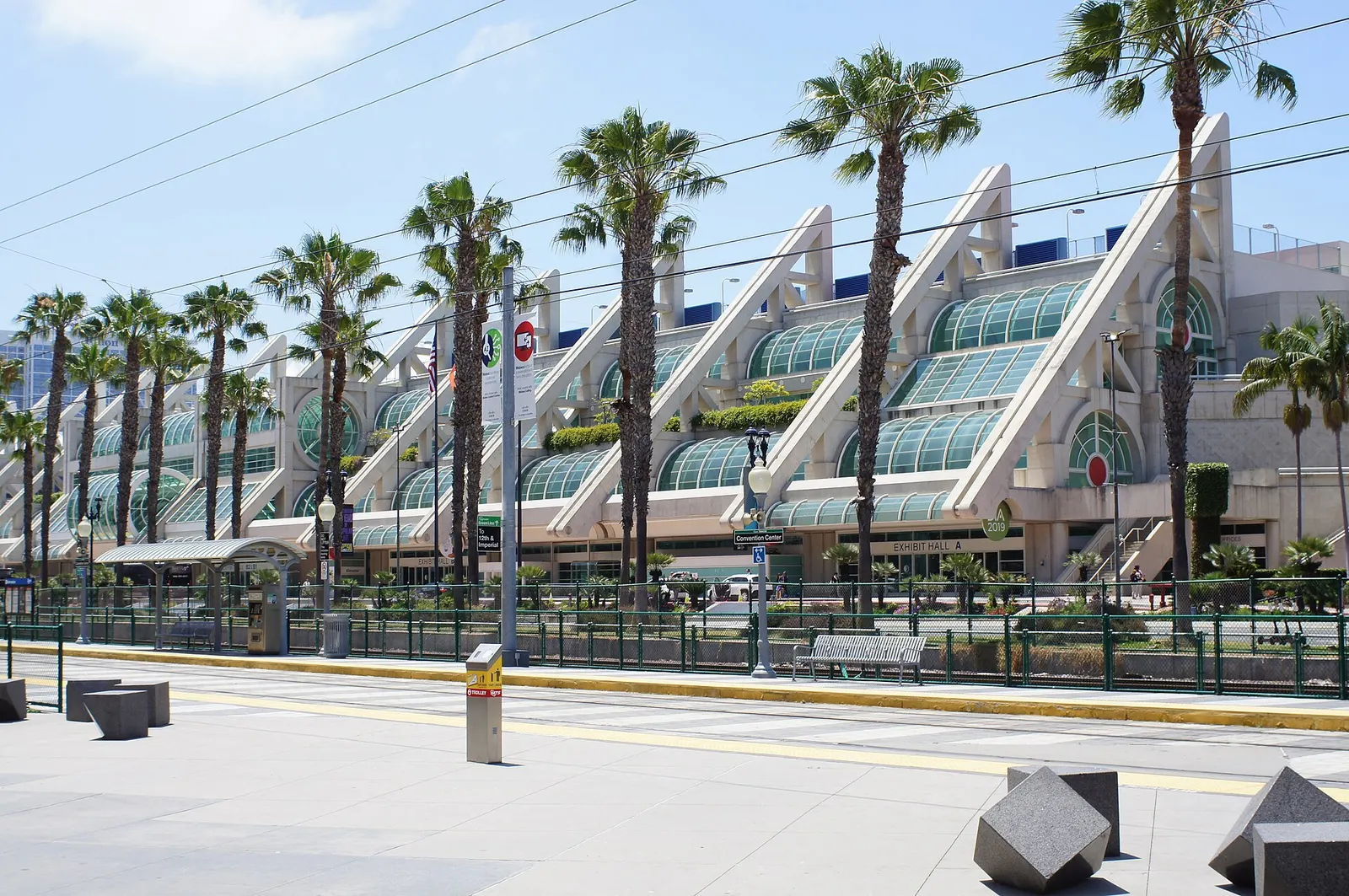 The San Diego Convention Center's glass-arched facade along the waterfront promenade
