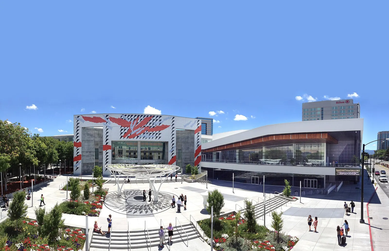 The San Jose McEnery Convention Center's painted facade and the glass expansion wing, seen across the plaza